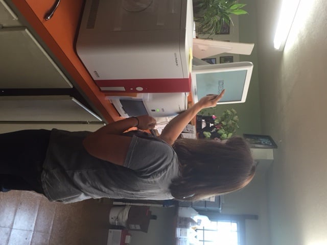 vet standing in front of a computer
