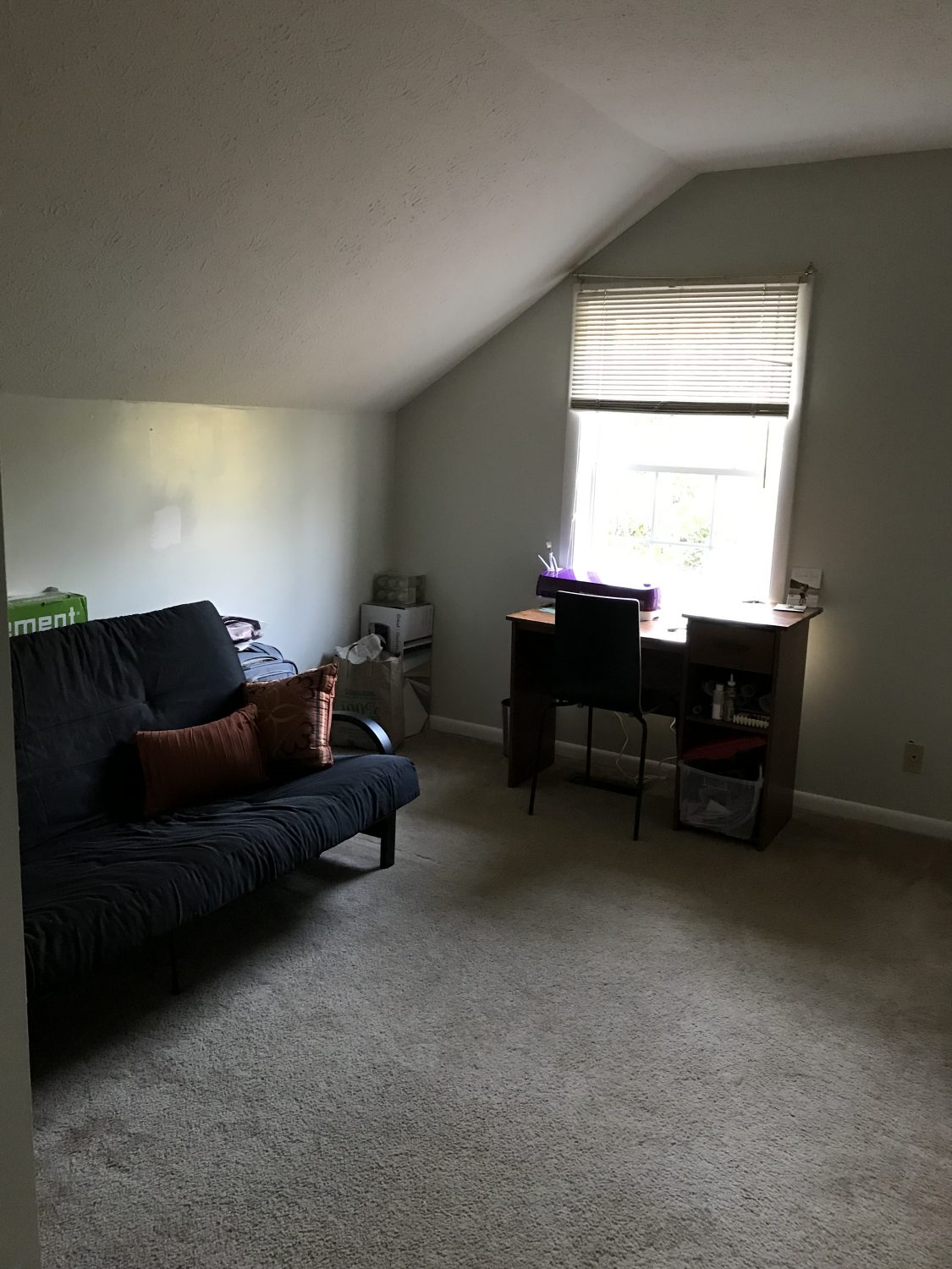 a room with a couch and desk